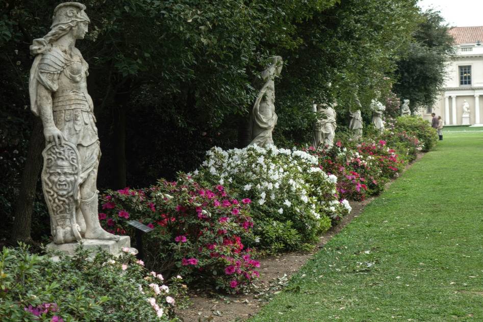 Bronze angel sculpture in a lush backyard setting